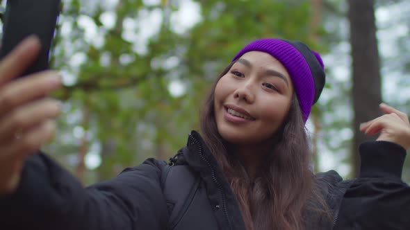 Asian Female Traveler Taking Selfie in Nature
