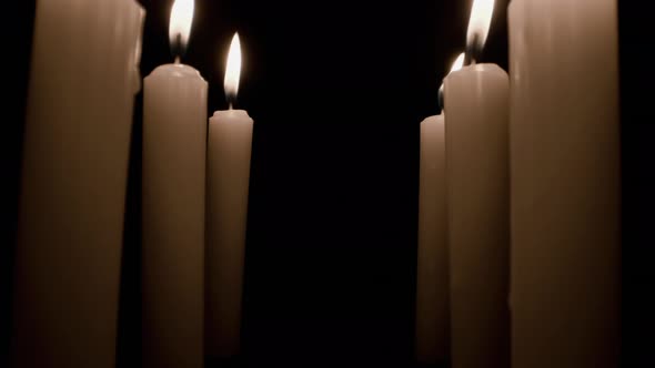 Burning Candle Against Black Background