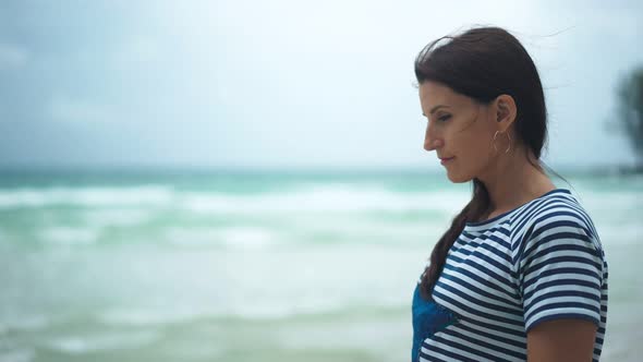 Pensive Woman Looking at Ocean and Thinking About Life at Sunset