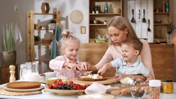 Delighted Caucasian Siblings Making Cake with Mom