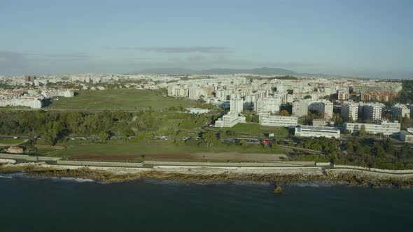 Aerial close up view of the marginal with ocean and traffic on the coast in sunny day, Oeiras, Portu