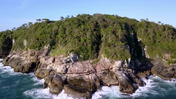 Aerial flying over the Trilha da Sepultura hiking area and revealing Bombinhas town on background