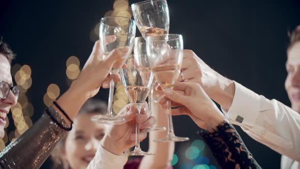 Close Up of Happy Faces of Young Friends Having Rest Together Clinking Glasses of Champagne