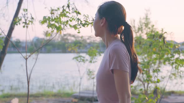 Asian young beautiful sport woman running on street in public park.