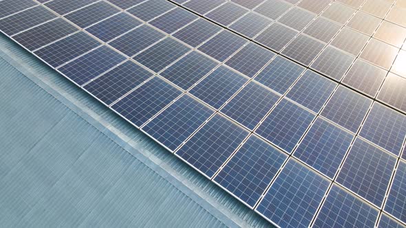 Closeup of surface of blue photovoltaic solar panels mounted on building roof for producing