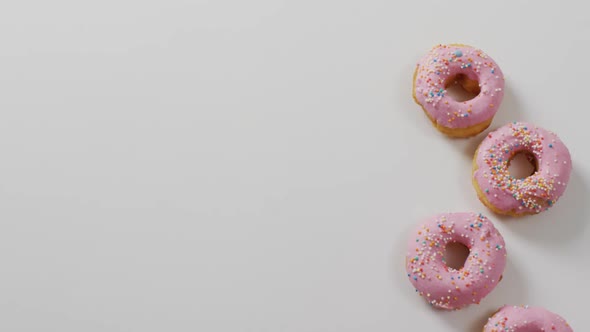 Video of donuts with icing on white background