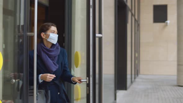 Business Lady Leaving Office Building and Removing Safety Mask Outdoors