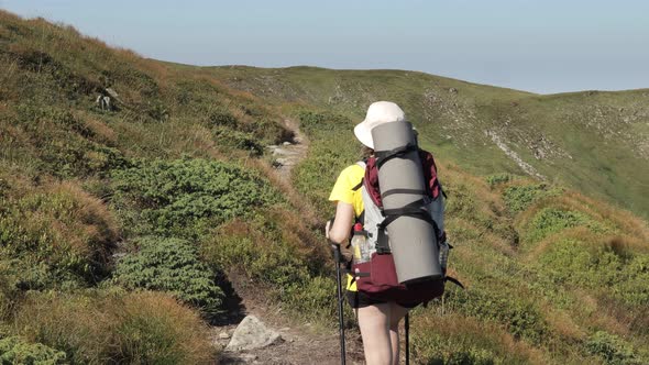 Woman Tourist walking on top of mountain. Hikers travel enjoy life scenic nature landscape