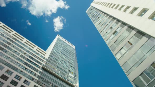 Time-lapse Blue Cloudy Sky White Glass Buildings 