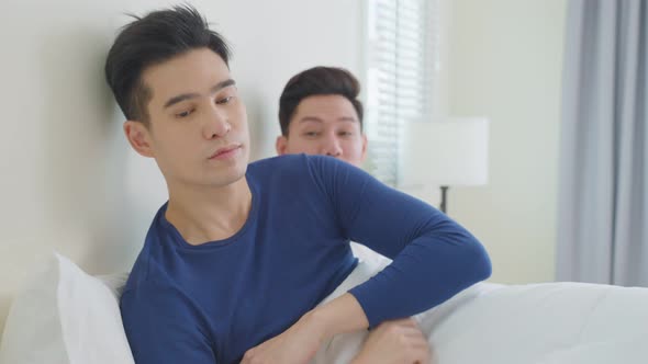 Asian handsome gay couple apologizing offended boyfriend for mistake.