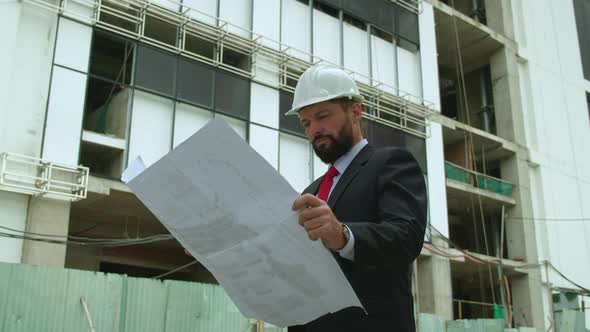 An Engineer Developer at a Construction Site Checks on the Drawings at What Stage the Construction