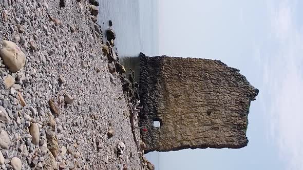 Vertical orientation video: An unusual rock standing in the sea