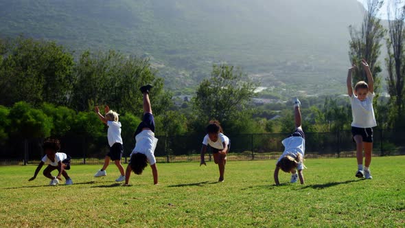 Children performing cart wheel during race