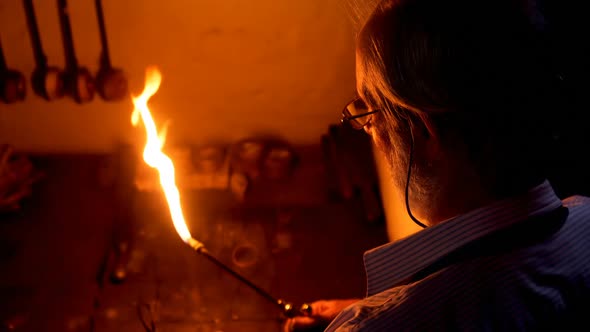Goldsmith holding welding torch in workshop 4k