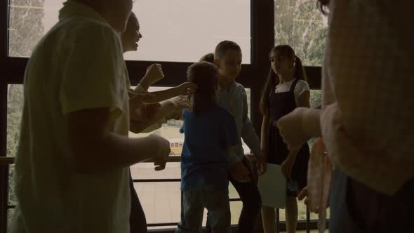 School Bullies Pushing Helpless Classmate Together Standing in Circle Hallway