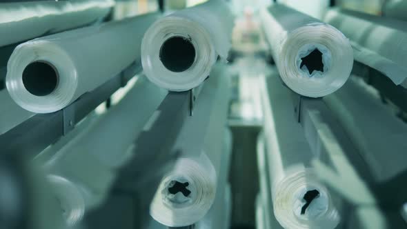 Close Up View of White Paper Rolls Moving Vertically