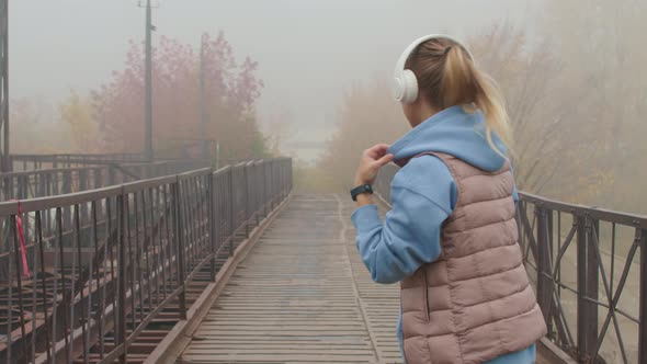 Slowmo of Woman Jogging on Foggy Morning