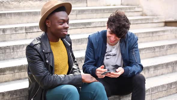 Multiracial male friends meeting in London, talking and having fun together