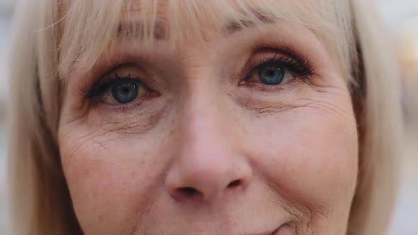 Closeup Elderly Female Face Blue Eyes Mature Smiling Woman Satisfied with Ophthalmic Procedure