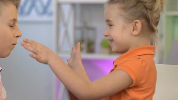 Cheerful Children Fooling Around, Boy Making Faces to Entertain Girl, Having Fun