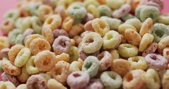 Video of colorful breakfast round cereals on white background