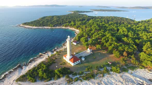 Aerial view of lighthouse, Croatia on forested shore