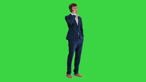 Handsome Young Businessman Talking on the Phone on a Green Screen, Chroma Key
