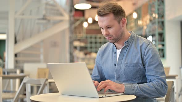 Serious Casual Man Closing Laptop and Going Away 