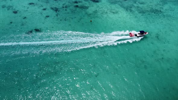 Steady top down shot of speedboat riding with highspeed on beautiful indian ocean
