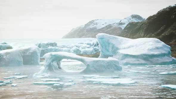 Antarctic Icebergs Near Rocky Beach