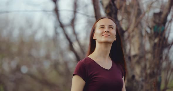 Beautiful Girl Walks Among the Trees in Early Spring