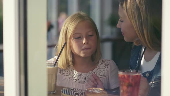 Mother and daughter having breakfast