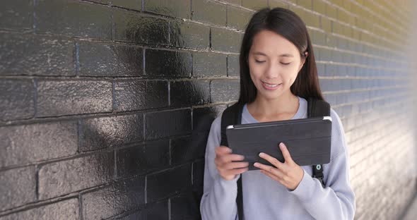 Woman looking at tablet computer at outdoor