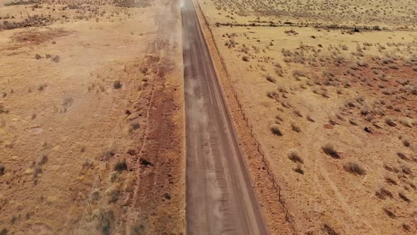 Dust Clouds Lead to Station Wagon on Open Desert Road, Aerial
