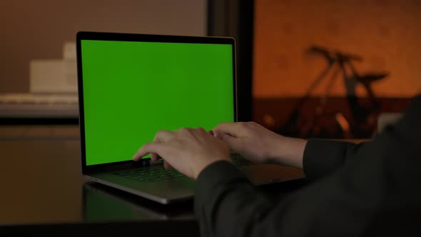 Faceless Unrecognizable Man Typing Something on Green Screen Laptop