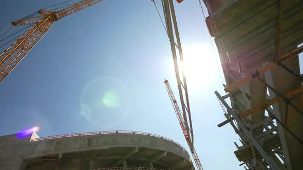 Tower Crane Puts Element of Roof Carcass on Stadium Building