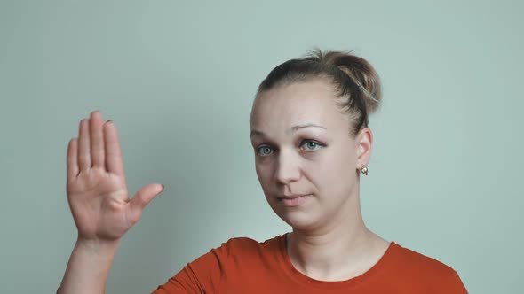 The Woman Shows a Gesture of Help to the Palm and Asks for Help