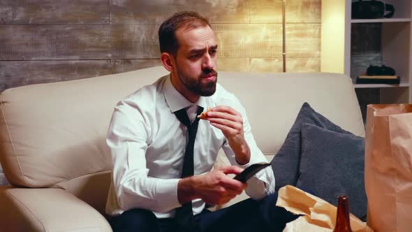 Businessman with Tie Eating a Burger While Watching Tv