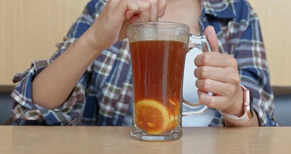 Woman drink of lemon tea in restaurant