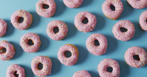 Video of donuts with icing on blue background