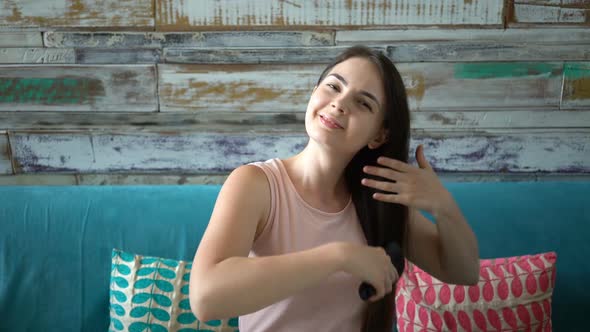 Woman on Sofa Combing Hair