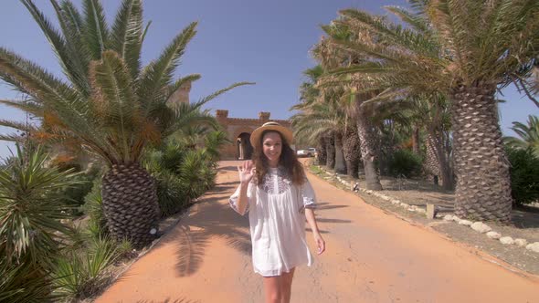 Beautiful woman walking near old luxury villa in Italy