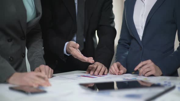 Two Manager Ladies and Male Boss Comparing Sales Charts and Investment Plans