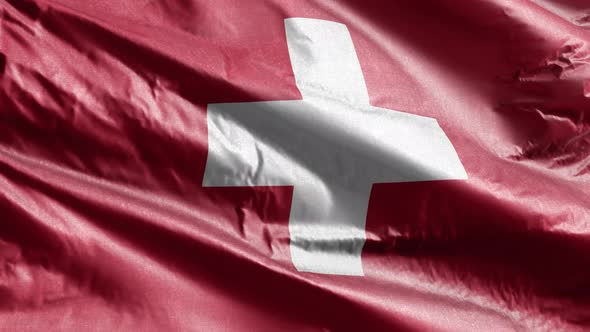 Switzerland textile flag waving on the wind. Slow motion. 20 seconds loop.