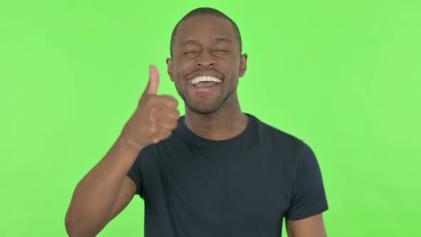 Thumbs Up By Young African Man on Green Background