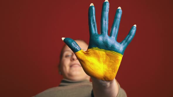 Hand of a Girl With the Flag of Ukraine Asks to Stop the War