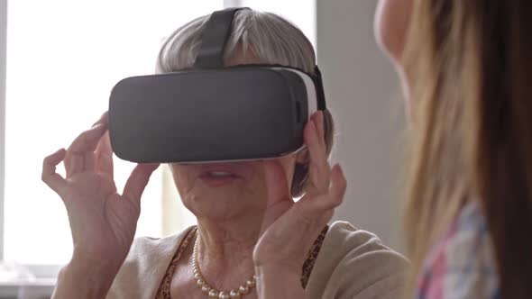 Curious Elderly Woman in VR Goggles