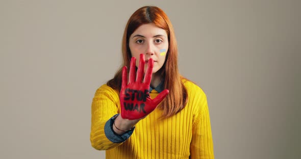 Girl Raises Her Red Hand with Stop War to Stop the Horrors in Ukraine