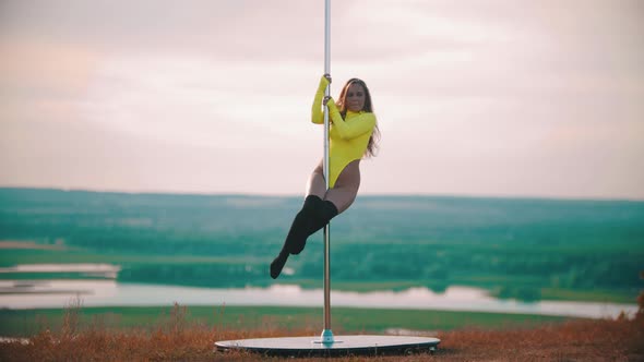 Woman in Yellow Swimsuit Jumping on the Pole