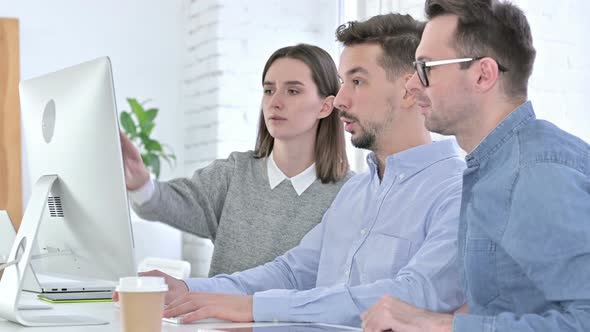 Serious Startup Team Working Together on Desktop